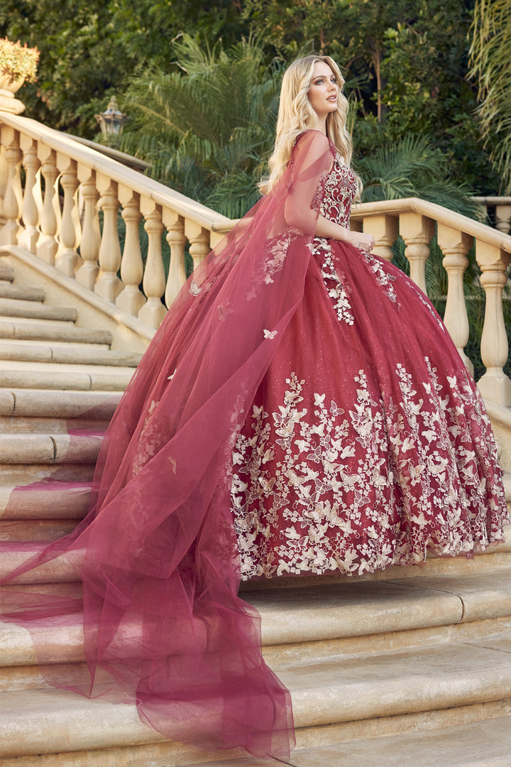 Juliet 1442 butterfly appliqué cape quinceanera dress three-quarter view with long sheer cape on staircase