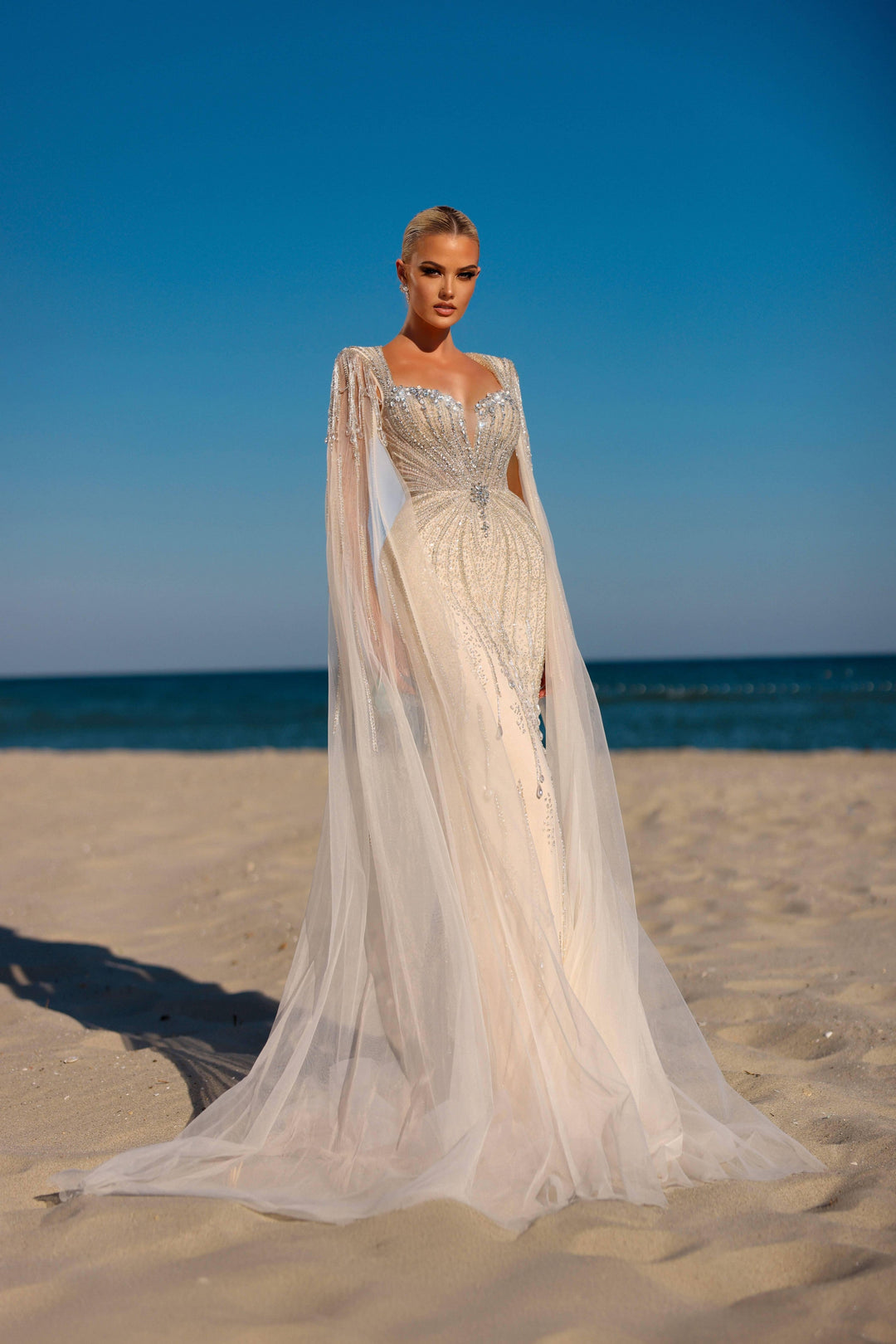 Delilah HM329 Plunging Sweetheart Beaded Mermaid Gown with Crystal Fringe Straps and Cape Sleeves - White front view