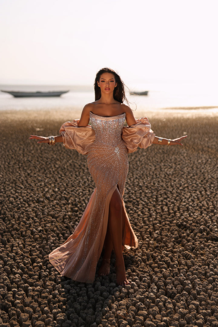 Delilah LD11438 Strapless Beaded Mermaid Gown with Satin Puff Sleeves and Overskirt - Champagne front view
