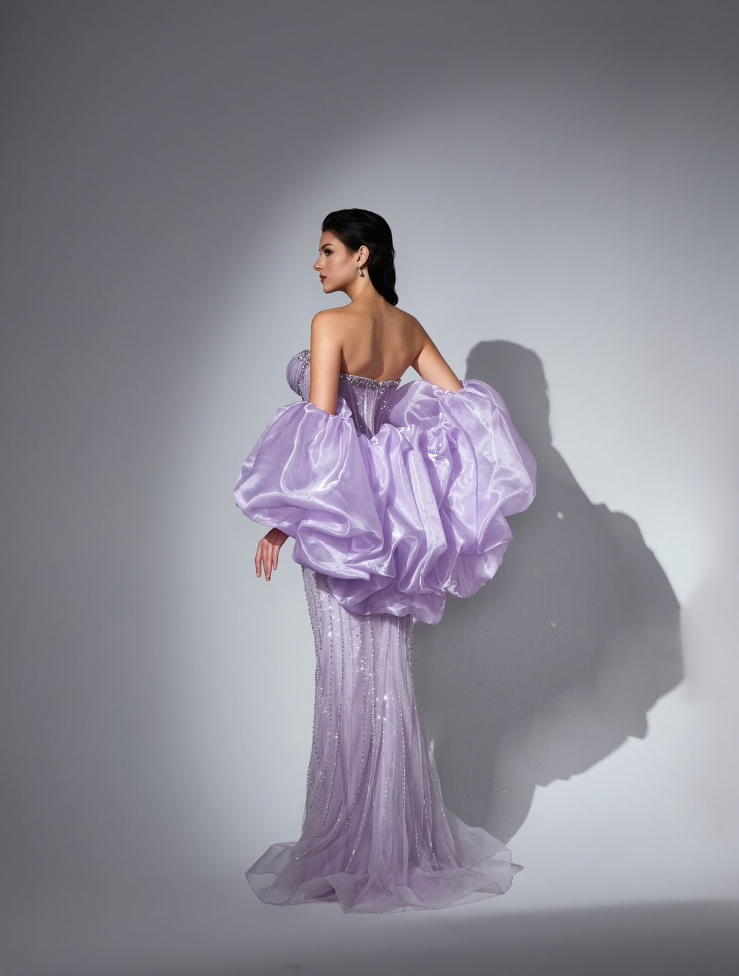 Delilah LD21161 Strapless Swirl Crystal Corset Mermaid Gown with Puff Sleeves and Slit - Lavender back view