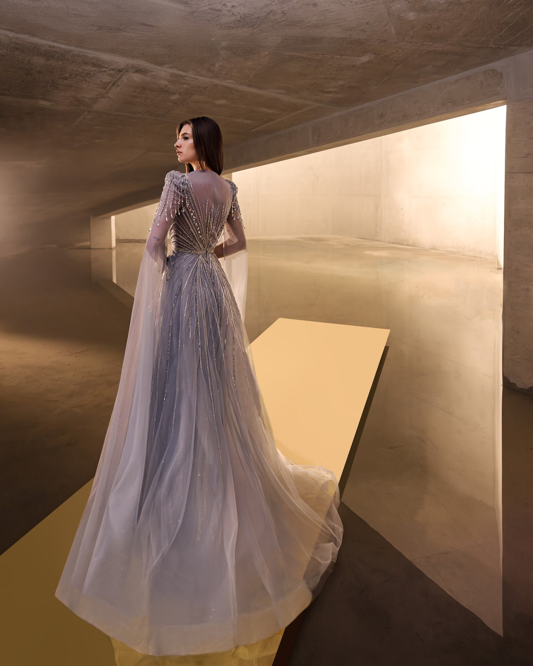 Delilah LD11670 Illusion Neck Long Sleeve Cape Beaded A-Line Gown - G.Blue back view