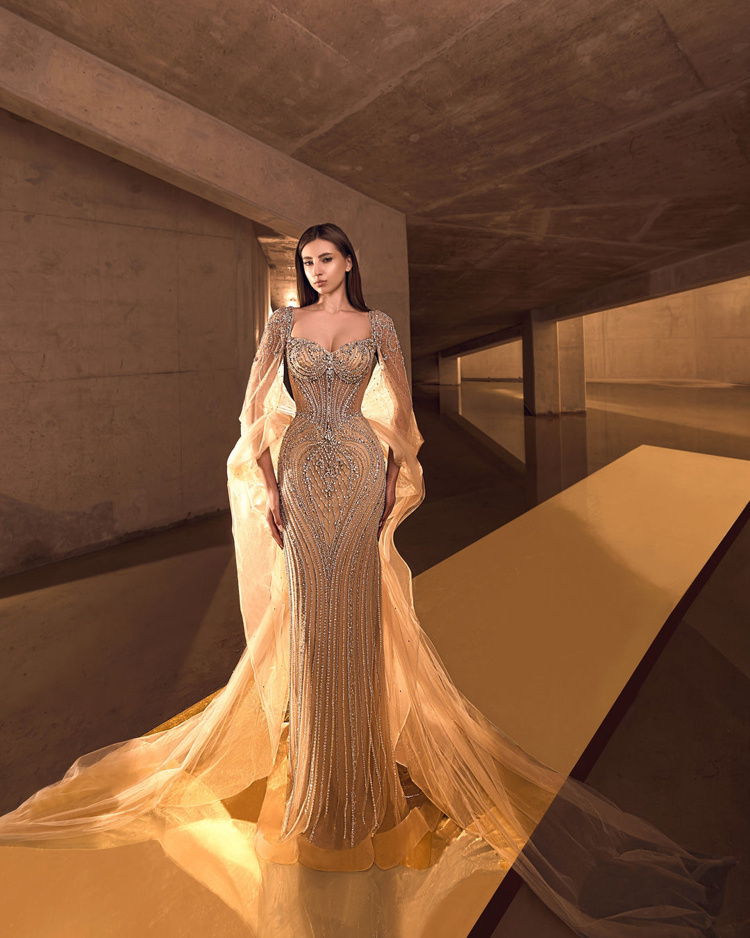 Delilah LD12076 Crystal Corset Mermaid Gown with Choker and Floor-Length Cape Sleeves - Champagne front view
