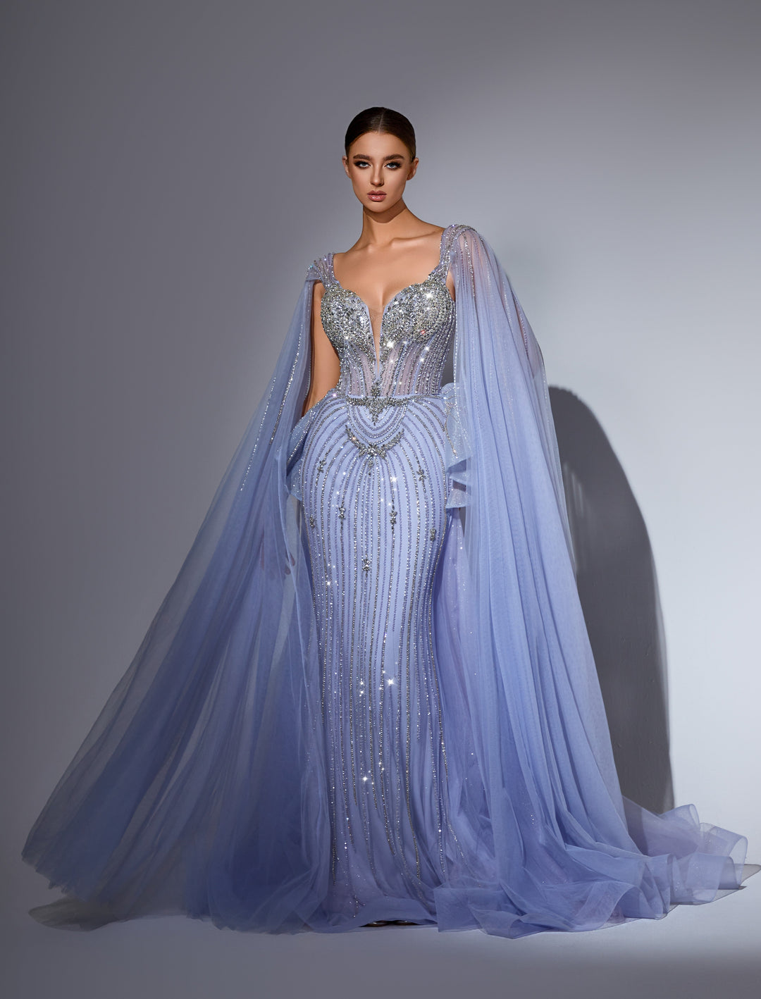 Delilah LD11214 Plunging Sweetheart Beaded Corset Mermaid Gown with Cape Sleeves and Overskirt - Blue front view