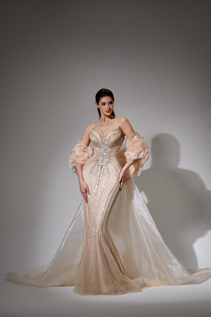 Delilah SH12052 Plunging Beaded Corset Mermaid Gown with Rosette Arm Puffs and Overskirt - Champagne front view